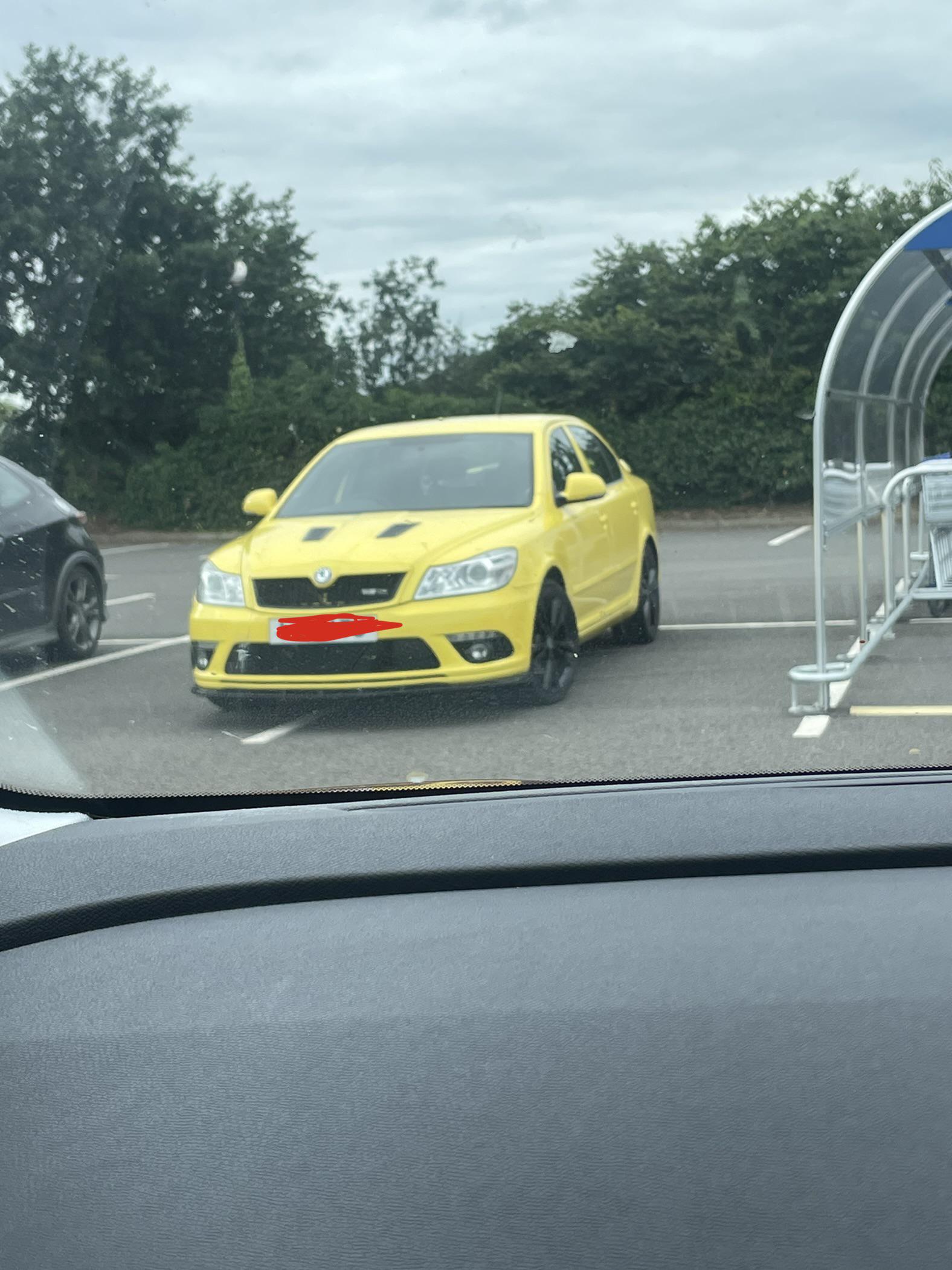 Yellow Skoda parked poorly