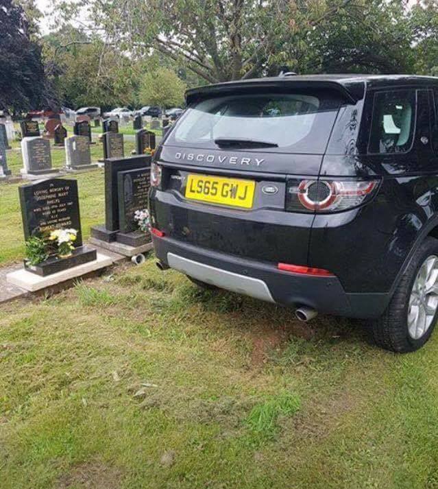 Land rover parked on grave.