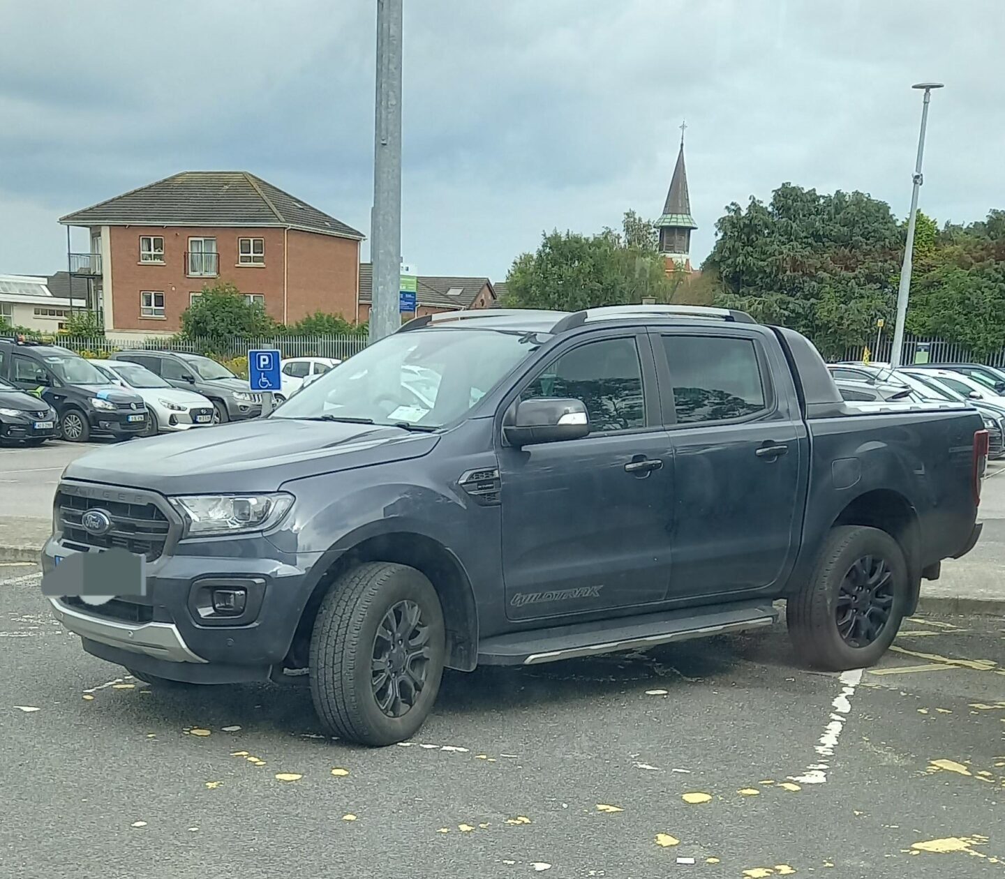 Vehicle parked across disabled parking.