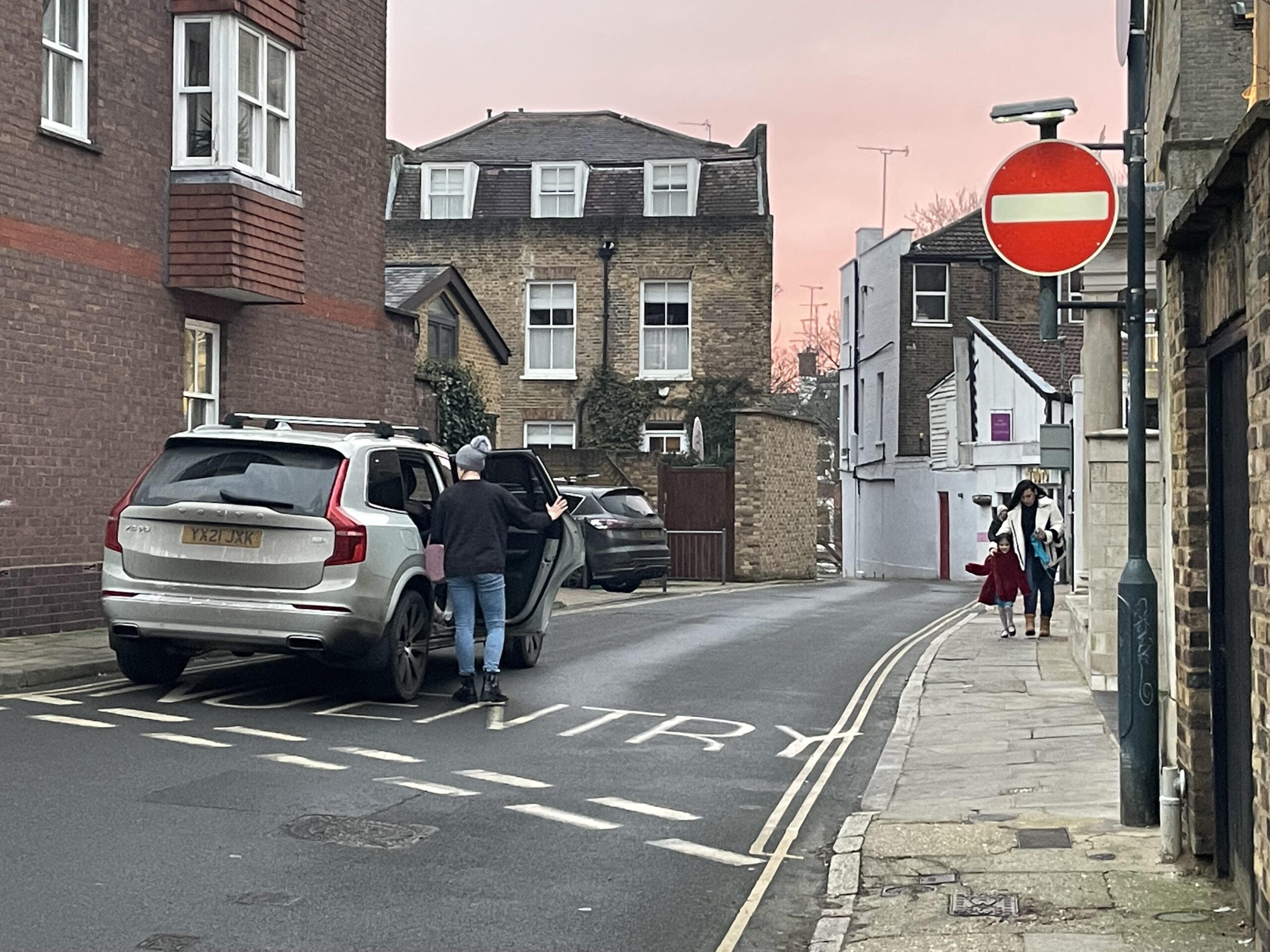 Volvo parked on double yellows, the wrong way on a one way street.